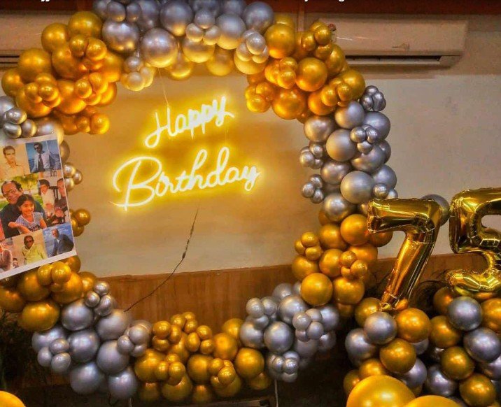Gold and silver 75th birthday balloon wreath with neon happy birthday sign
