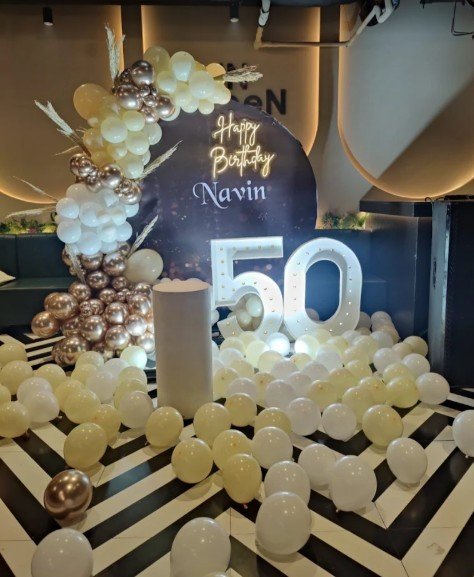 Golden 50th birthday balloon setup for Navin with marquee numerals