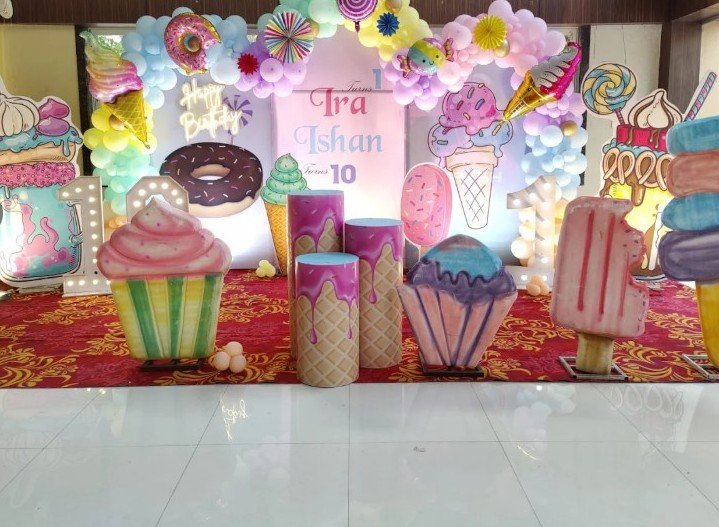 Ice cream and candy themed double birthday backdrop for Ira and Ishan