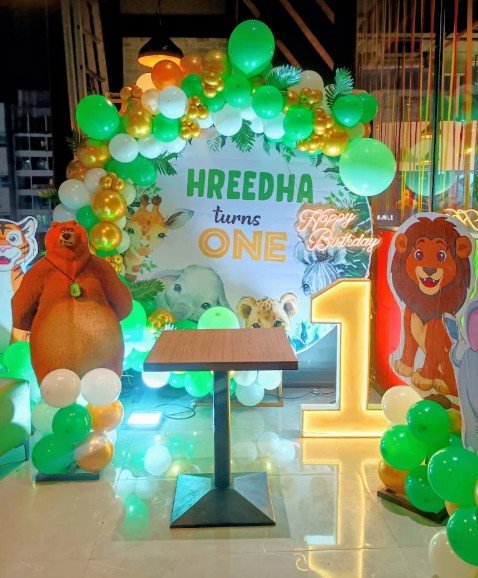 Jungle theme first birthday setup for Hreedha with glowing numeral